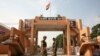 India's Border Security Force (BSF) soldiers patrol in front of the golden jubilee gate at the Wagah border, on the outskirts of the northern Indian city of Amritsar, Nov. 3, 2014. 