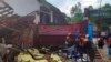 In photo released by Indonesian National Search and Rescue Agency (BASARNAS), rescuers inspect a school damaged by earthquake in Cianjur, West Java, Indonesia, Monday, Nov. 21, 2022. (BASARNAS via AP)