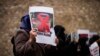 A woman holds a photograph of far-right activist Rasmus Paludan during a protest outside the Swedish consulate in Istanbul on Jan. 28, 2023. Paludan infuriated Turkey by staging a Quran-burning protest in Sweden on Jan. 21. Last week, he replicated the stunt in Copenhagen.
