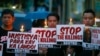 FILE - Protesters hold placards in a candlelit protest against the extrajudicial killings in President Rodrigo Duterte's "War on Drugs" campaign in suburban Quezon city, northeast of Manila, Philippines, Oct. 8, 2016.