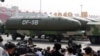 FILE - Military vehicles carrying DF-5B intercontinental ballistic missiles travel past Tiananmen Square during a military parade in Beijing, China, Oct. 1, 2019. 