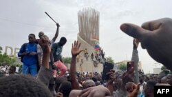 Supporters of the Nigerian security forces that took control of the country gather during a demonstration outside the national assembly in Niamey on July 27, 2023.