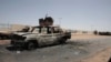 Kendaraan militer yang hancur terlihat di selatan di Khartoum, Sudan, Kamis, 20 April 2023. Sepanjang malam hingga Kamis pagi, tembakan terdengar hampir terus-menerus di seluruh Khartoum. (AP/Marwan Ali)