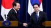 FILE - South Korean President Yoon Suk Yeol, left, and Japanese Prime Minister Fumio Kishida, right, shake hands after a news conference Tokyo, March 16, 2023. The leaders, will meet — along with US leaders — again in August.