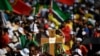 Pilgrims hold a cross-shaped sign as they wait for the start of the opening mass of the World Youth Day (WYD) gathering of young Catholics in Eduardo VII Park in Lisbon on Aug. 1, 2023. 