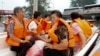 In this photo released by Xinhua News Agency, residents are rescued by boat in the flood-hit Fangshan district on the outskirts of Beijing, Aug. 2, 2023. 