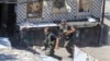 FILE - Members of the Palestinian Fatah group run to take position during a third day of clashes that erupted with Islamist factions in the Palestinian refugee camp of Ein el-Hilweh near the southern port city of Sidon, Lebanon, on July 31, 2023. 