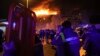 Seorang petugas medis berdiri di dekat ambulans yang diparkir di luar gedung Balai Kota Crocus yang terbakar di tepi barat Moskow, Rusia, Jumat, 22 Maret 2024. (Foto: AP)