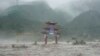 A traditional gate is inundated by flood waters in the Miaofengshan area on the outskirts of Beijing, Aug. 1, 2023. 