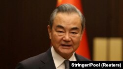 Chinese Foreign Minister Wang Yi poses as he meets Turkish Foreign Minister Hakan Fidan (not seen) in Ankara, July 26, 2023.
