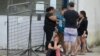 Inmates' relatives wait outside Medicina Legal in Guayaquil, Ecuador, on April 15, 2023, after clashes broke out in the Guayas 1 prison. Another 11 prisoners were injured in another bout of violence in the Guayas 1 prison over the weekend, the prosecutor's office said.