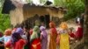 A group of Meira Paibi women of the Meitei community gather in front of the partially charred house of an alleged suspect of a viral sexual assault video in Pechi Awang Leikai village of the Thoubal district of north eastern state of Manipur, India, July 22. 2023. 