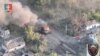 A tank burns as Ukrainian Armed Forces members liberate the town of Staromaiorske, in the Donestk region, Ukraine, in this still image obtained from video social media and released July 27, 2023. (35th Separate Marines Brigade of the Ukrainian Armed Forces/via Reuters)