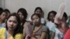 FILE - A community health worker holds up contraceptives during a lecture on family planning at a reproductive health clinic run by an NGO in Tondo city, metro Manila, Jan. 12, 2016.