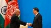 Chinese Premier Li Keqiang (R) shakes hands with Afghan President Ashraf Ghani at the opening ceremony of the 4th Ministerial Conference of Istanbul Process of Afghanistan at the Diaoyutai Guesthouse in Beijing, October 31, 2014.