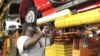 FILE - An assembly worker works on 2015 Ford Mustang vehicles on the production line at the Ford Motor Flat Rock Assembly Plant in Flat Rock, Michigan, Aug. 20, 2015. 