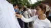A woman finds her name on a list during a local commune election in Phnom Penh, file photo. 