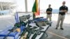 Customs and Border Protection officers stand by guns confiscated along the U.S.-Mexico border