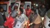 Pakistani volunteers carry the body of a militant killed during a crackdown by security forces in Quetta, Dec. 19, 2014.