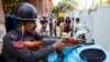 Pakistani cricket fans enter the Gaddafi stadium under tight security to watch Pakistan vs Zimbabwe match in Lahore, Pakistan, May 22, 2015. 