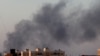 Black smoke marks where clashes are taking place between pro-government forces and an alliance of anti-Moammar Gadhafi rebels who have joined forces with the Islamist group Ansar al-Sharia in Benghazi, Libya, Aug. 15, 2015. 