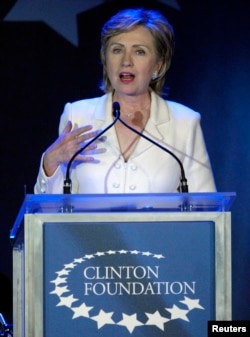 FILE - Then-Senator Hillary Clinton, wife of former U.S. President Bill Clinton, speaks at a fundraising gala for the Clinton Foundation in New York, Oct. 28, 2006.