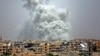 FILE - Smoke billows out from Raqqa following a U.S.-led coalition airstrike, July 28, 2017.