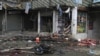 An Afghan security forces member inspects at the site of a suicide attack near a bank in Jalalabad, east of Kabul, Afghanistan, April 18, 2015. 