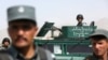 Afghan security forces inspect site of suicide attack after clashes with Taliban fighters at the gate of an intelligence facility in Kabul, July 7, 2015.