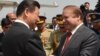 Chinese President Xi Jinping, left, greets Pakistan's Prime Minister Nawaz Sharif at Nur Khan air base in Rawalpindi, in this handout photograph released by Pakistan's press department on April 20, 2015. 