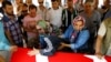 Relatives of Gulsen Bahadir, a victim of Tuesday's attack on Ataturk airport, mourn at her flag-draped coffin during her funeral ceremony in Istanbul, Turkey, June 29, 2016. 