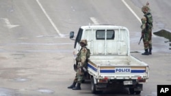 Armed soldiers patrol a street in Harare, Zimbabwe, Nov. 15, 2017. 