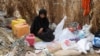 FILE - A Yemeni woman sits in the remains of a home in a neighborhood ravaged by Tropical Cyclone Sagar, in the port city of Hodeidah, Yemen, May 19, 2018. Tropical Cyclone Luban devastated the southeastern coast of Yemen earlier this week.