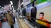 A man watches a television broadcasting a news about detained two Japanese, at an electronics store in Tokyo, Jan. 20, 2015. 