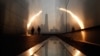 A man walks through the 9/11 Empty Sky memorial at sunrise across from New York's Lower Manhattan and One World Trade Center in Liberty State Park in Jersey City, New Jersey, September 11, 2013. 