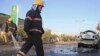 Afghan firefighters clear the site of a blast that killed a provincial judge in Jalalabad, capital of Nangarhar province, Afghanistan Wednesday, Jan. 7, 2015.