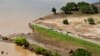 Aerial views shows a road that has been washed away by flood waters in Chokwe, Mozambique, Jan. 30, 2013.