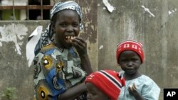 An unidentified woman and her two children beg for money and food.