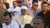 Mohammed Magarief (C), president of the Libyan National Assembly, attends Eid al-Fitr prayers in Benghazi August 19, 2012.