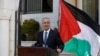 Palestinian Prime Minister Rami Hamdallah talks to media after the first unity government meeting in the West Bank city of Ramallah, June 3, 2014.