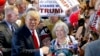 Republican presidential candidate Donald Trump, left, shouts to Secret Service agents that supporter Diana Brest, right, had been waiting in line since 2 a.m. to see the candidate speak at a rally, June 18, 2016, in Phoenix.