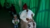 An elderly woman with a young child queues to receive her Pfizer COVID-19 vaccine at a clinic at Orange Farm, near Johannesburg, South Africa, June 3, 2021. 