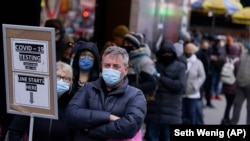 People wait in line at a COVID testing site in NYC on Dec. 13, 2021. (AP Photo/Seth Wenig, File)