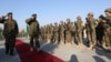 FILE - General Sher Mohammad Karimi, chief of staff of the Afghan army, second left, salutes soldiers during a ceremony in Laghman province, east of Kabul, Afghanistan, Jan. 11, 2015.