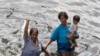 A boy watches another jump from a bridge to cool off in the river Nile during Eid al-Fitr in Cairo August 20, 2012. 