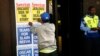 A newspaper vendor puts up posters outside the Pretoria Magistrates court where Oscar Pistorius appeared for a bail hearing, February 20, 2013.