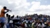 Striking miners listen to an address by their leader at the AngloGold Ashanti mine in Carletonville, northwest of Johannesburg October 19, 2012. 