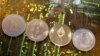 FILE - Representations of the Ripple, Bitcoin, Etherum and Litecoin virtual currencies, Feb. 13, 2018. Switzerland's government wants to look into the feasibility of launching its own state-backed cryptocurrency.