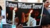 A boy holds a poster during a civil society protest rally against terrorism in Lahore, January 16, 2015.