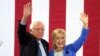 Democratic presidential candidate Hillary Clinton and Sen. Bernie Sanders wave to supporters with during a rally in Portsmouth, N.H., where Sanders endorsed her for president, July 12, 2016.